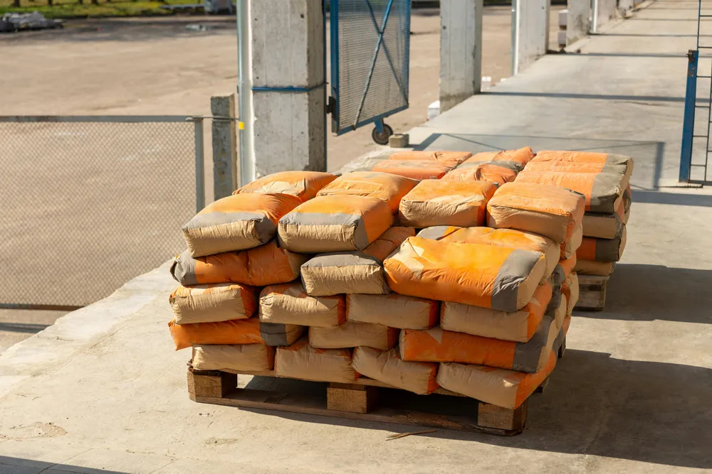 Pallet of stacked multi-wall paper sacks in an industrial yard